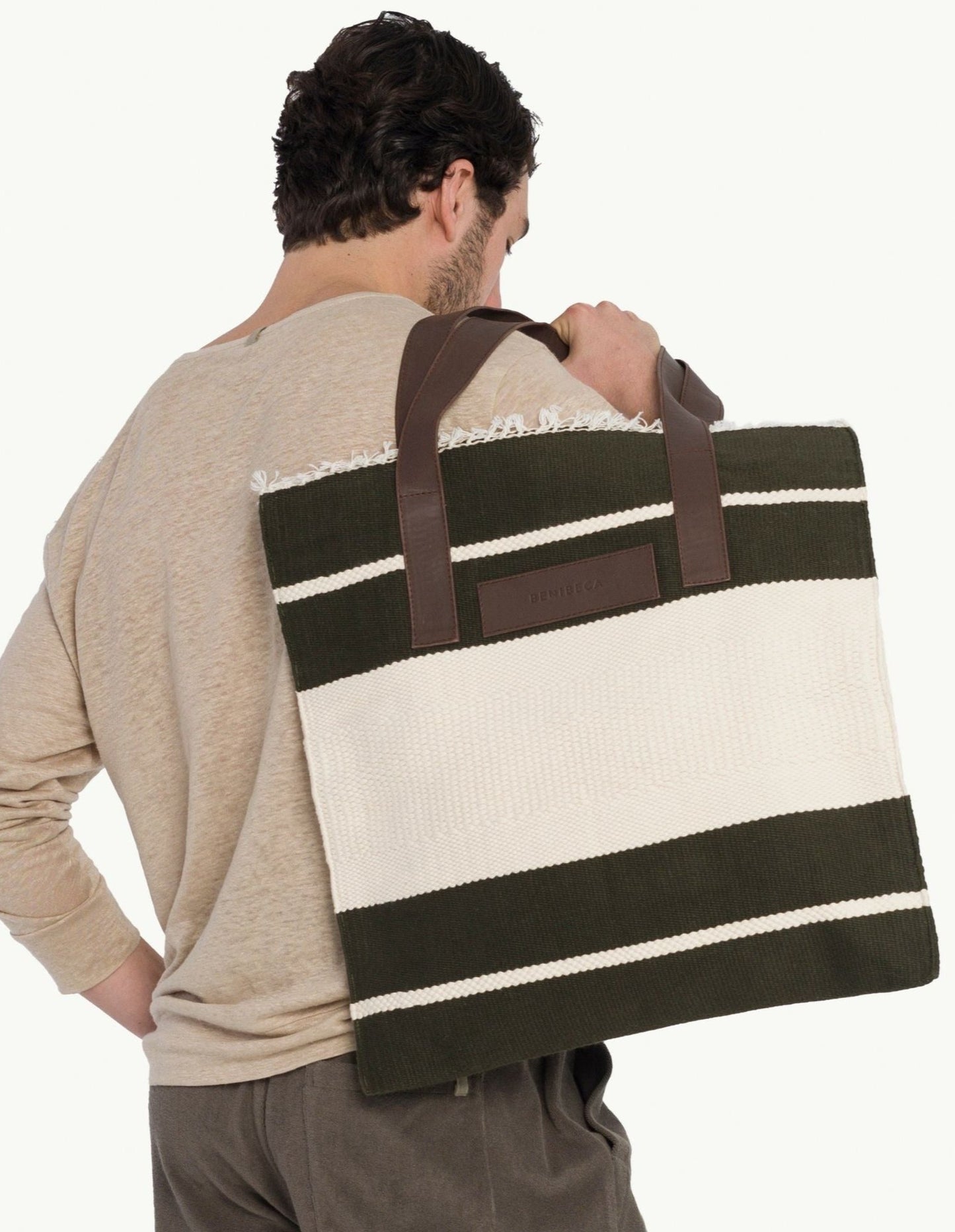 Explore our handcrafted tote bag, inspired by Peruvian artisanship. This two-tone cotton weave tote showcases naturally tanned crust cowhide and tocuyo cotton lining, complete with dual compartments and pockets for practical elegance. Browse our selection of Peruvian artisan tote bags.